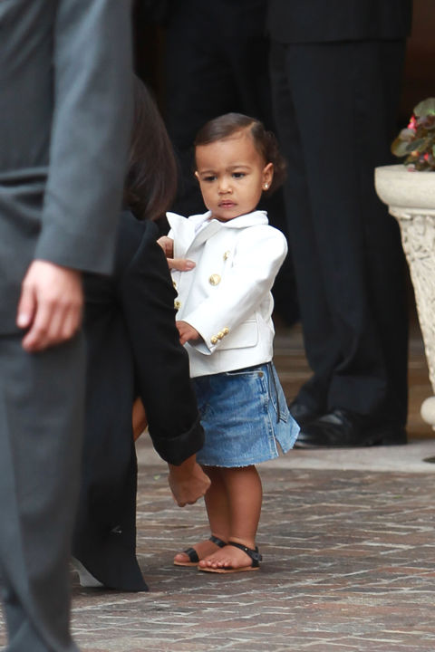 Opting for a denim skirt, the one-year-old wears one of the seasons key pieces with a white blazer and black sandals.