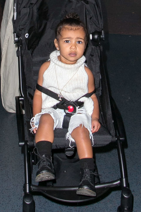 Hitting the airport in style, North makes us all want a sleeveless turtleneck sweater for the season.