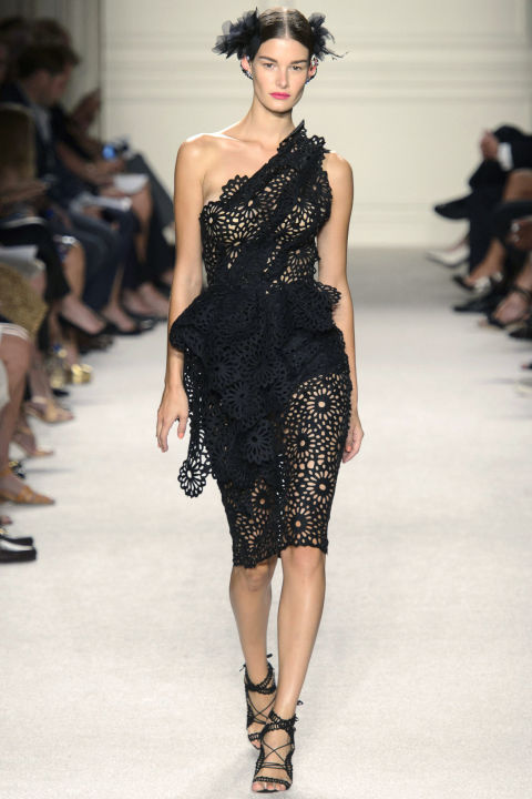 Open lace was crafted into body-shaping gowns with tucks and drapes that accentuated the curves of ladylike birds, and a lot of models walked out with their hair split into two buns pulled back with gauze hair ties.
