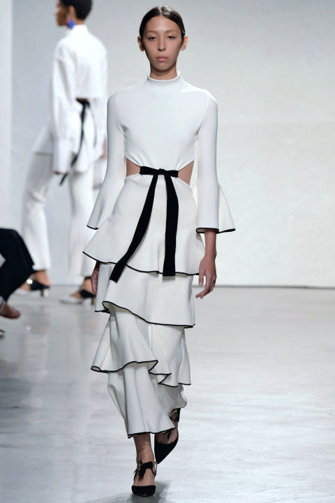 lamenco dresses were translated into modern shapes—in both white edged in black and black with red—with cleaner, spare silhouettes and looser ruffled tiers. Tiers that were echoed in the black bows gathering and cinching down the front of other raw-edged lace looks.