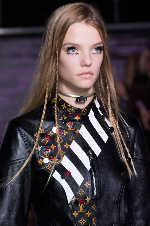 This season's braids—tight, streamlined and functional—are a major shift from the loose, bohemian ones that tend to pair well with airy white dresses and pop up at festivals, perhaps because this season's collections include more black leather and buttoned-up collars than ever before. At Louis Vuitton (left), thin, peek-a-boo braids added subtle texture (think of them as grown-up versions of the hair wraps we all got on vacation as kids), while Proenza Schouler, Céline and Public School showed hard, functional (if the goal is hair that never falls out or distracts) twists everyone already knows how to do.